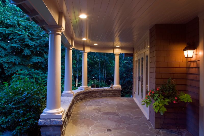 verandah with a roof, lighting and potted plants